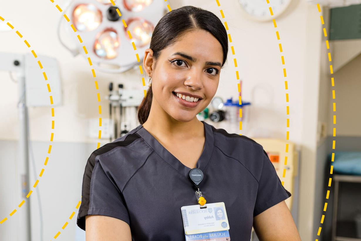 University of Rochester staff member poses for a photo in a hospital building.